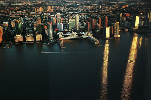 A ferry moves along the Hudson River with the New Jersey coast in view from the observation deck. (Spencer Platt/Getty Images)