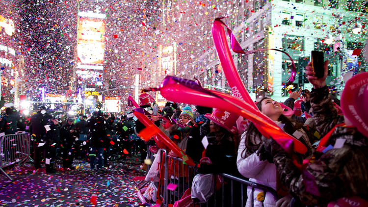Revelers are engulfed by confetti in Times Square just after midnight during New Year's Eve festivities in New York, Thursday, Jan. 1, 2015.